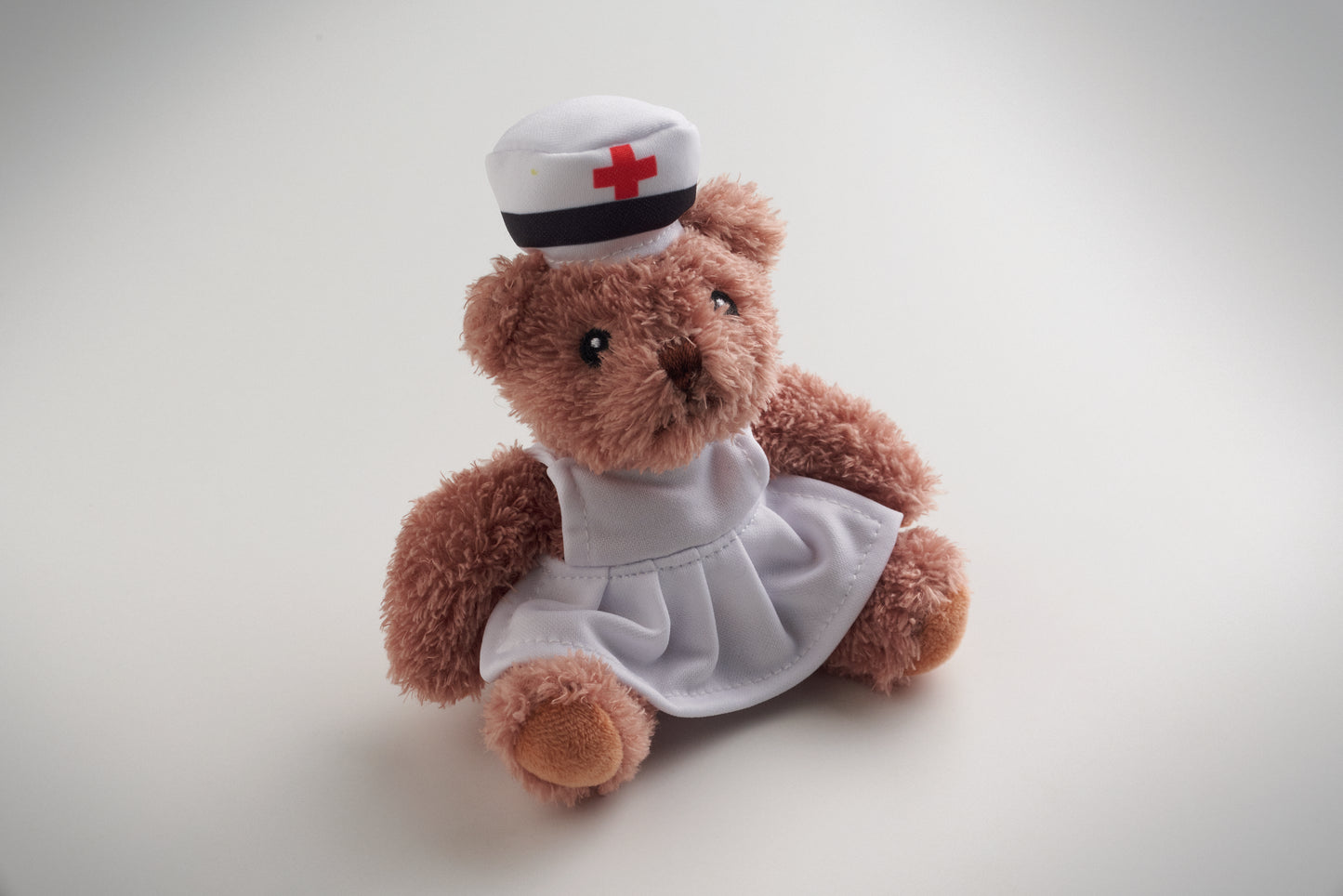 Teddybär aus Polyester gekleidet als Krankenschwester mit Kleid und Haube. Augen Nase
