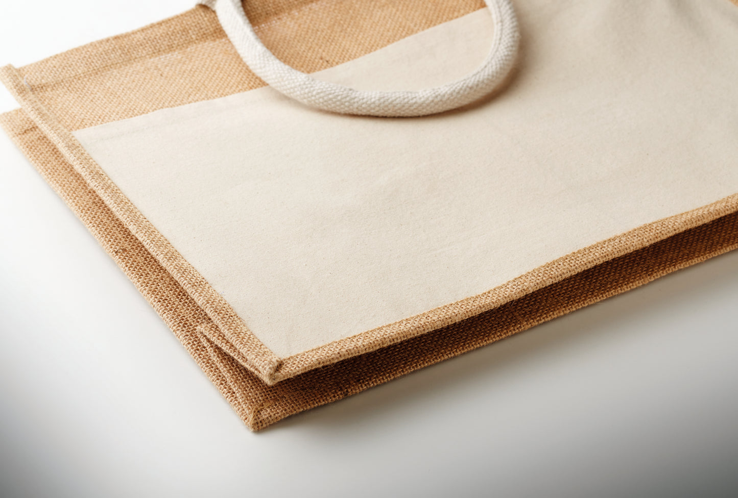Einkaufstasche aus laminierter Jute und 280 g/m² Baumwoll-Canvas mit Kordelgriffen. Große Fronttasche.