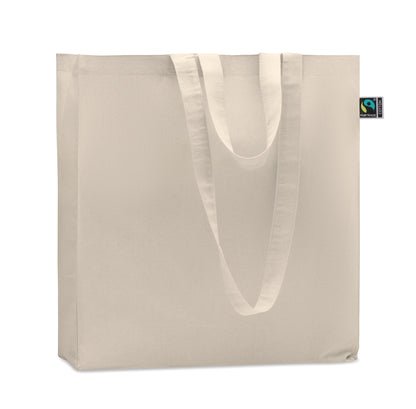 Einkaufstasche aus Fairtrade-Baumwolle. Lange Tragegriffe und seitliche Falz. 180 g/m².