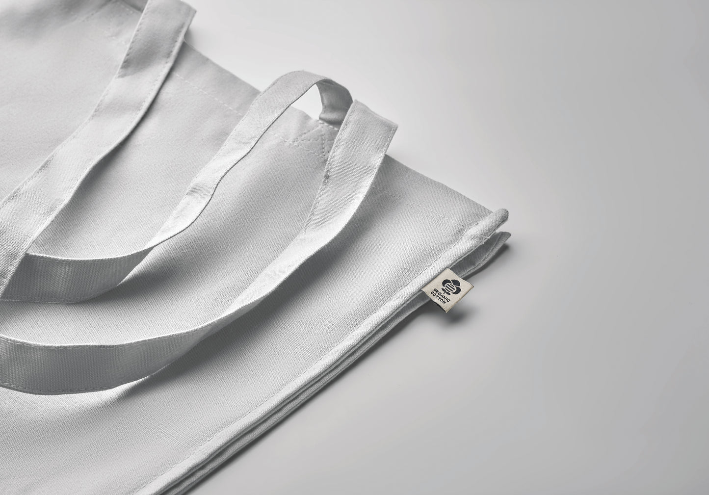 Einkaufstasche aus Organic Cotton mit langen Tragegriffen und Bodenfalz. 220 g/m².