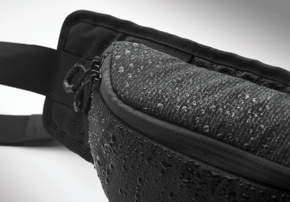 Gürteltasche aus wasserabweisendem 420D-Nylon mit 210D-Polyesterfutter. Reflektierender Streifen. Komplett gepolstertes Hauptfach. Große