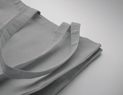 Einkaufstasche aus Fairtrade-Baumwolle mit langen Tragegriffen und Bodenfalz. 180 g/m².