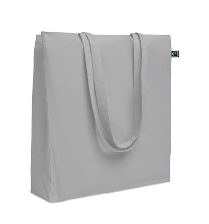 Einkaufstasche aus Fairtrade-Baumwolle mit langen Tragegriffen und Bodenfalz. 180 g/m².