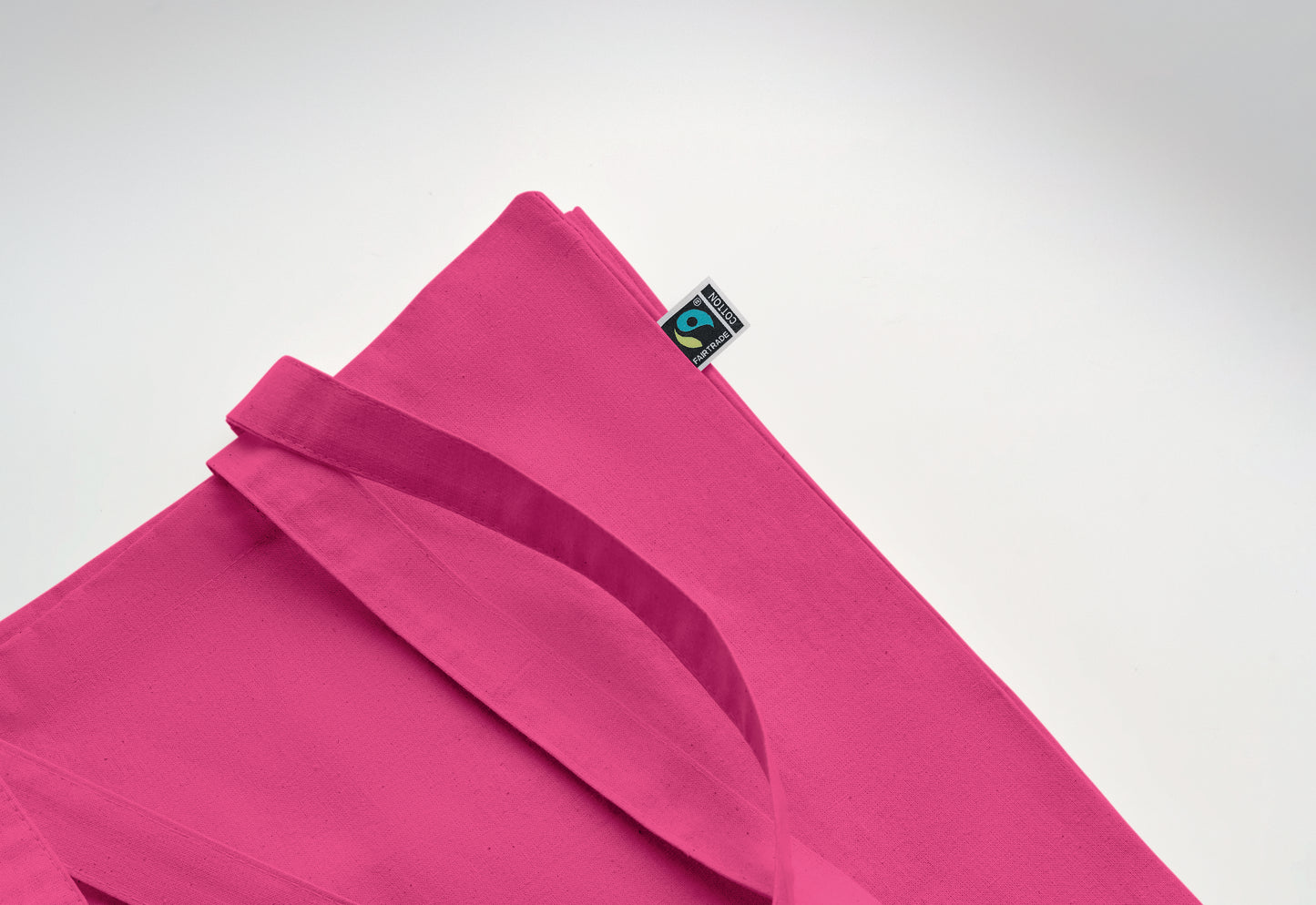 Einkaufstasche aus Fairtrade-Baumwolle mit langen Tragegriffen und Bodenfalz. 180 g/m².