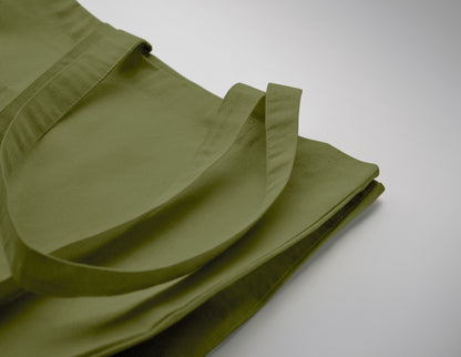 Einkaufstasche aus Fairtrade-Baumwolle mit langen Tragegriffen und Bodenfalz. 180 g/m².